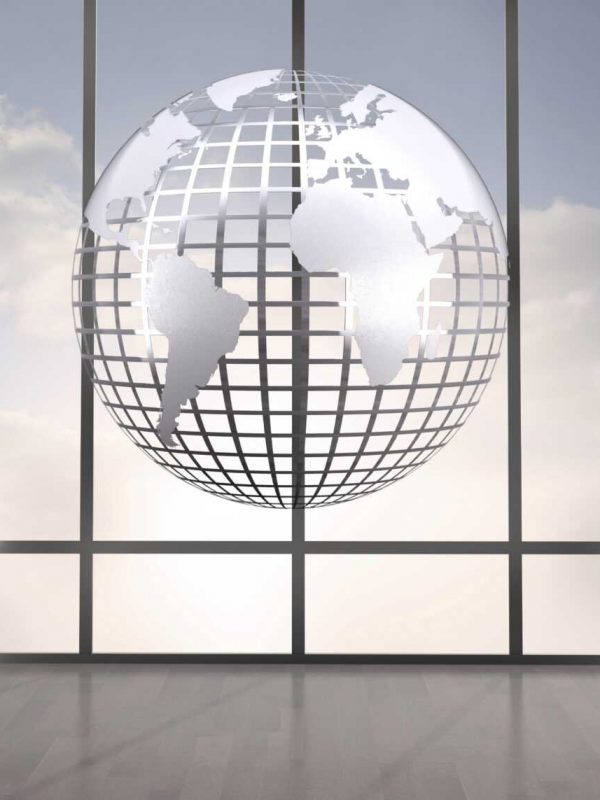 Silver globe floating in room